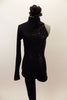 Black high neck unitard has one long leg and one sleeve & open back. There is a swirling pattern of black sequin along  left side. Has black hair accessory. Front