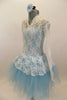 Pale blue leotard with romantic tutu of layered pale blue tulle, sits below a long sleeved ivory  V-neck lace dress with peplum. Comes with matching hair piece. Left side