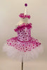 White satin leotard has fuchsia polk-a-dot overlay with bodice ruffle and attached skirt which sits on top of white tutu. Has matching satin ruffled clown hat. Right side