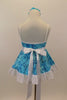 Camisole leotard dress has swirls  of blues on aqua base. Has a white petticoat and wide lace trim. White satin waist sash had a crystal heart. Has floral hair accessory. Back
