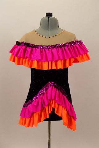 Black tunic style leotard dress has nude drop shoulder with orange & hot pink ruffles. The bottom has matching ruffled edge that comes up in the front. Comes with hair accessory. Front