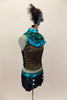 Black & gold lace halter has separate ruffled high neck turquoise collar. Lace shorts have turquoise piping & button accents. Has large feather hair accessory. Right side