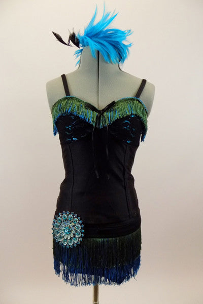 Roaring 20s style costume has bodice with lace bra & green-turquoise fringe. Black briefs have the matching fringe and a huge round crystal brooch at hip. Has turquoise feather hair piece. Front