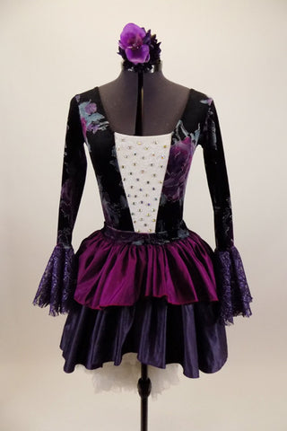 Jewel-tone velvet floral long sleeved leotard has white lace crystaled front torso & trumpet lace sleeves. Has pull-on skirt with ruffled jewel toned layers & matching floral hair accessory. Front