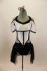 Armor themed white half top has drop cap sleeves. Front of the crystaled bodice comes to point  Black brief & skirt has panels of tulle & sequined sheer. Front