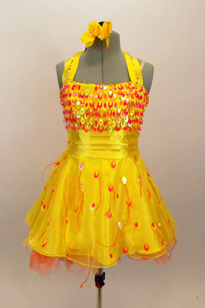 Orange & yellow paillettes, feathers & crystals adorn yellow satin dress with halter neck, skirt with yellow base on orange petticoat & matching hair accessory. Front