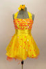 Orange & yellow paillettes, feathers & crystals adorn yellow satin dress with halter neck, skirt with yellow base on orange petticoat & matching hair accessory. Front