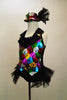 A black satin leotard & attached vest of colourful sequin patches & black satin lapel covered in crystals. Has sparkle tulle bustle & matching sequined top hat. Left side