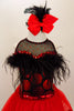 Dress has bodice with sweetheart neck polka dots & black mesh covered with crystals & feather trim. Skirt is red tricot with black satin hem. Has hair accessory. Front zoomed