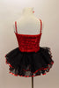 Red sparkle sequin bodice has black satin insert  with sequined-crystal buttons, silver cording & crystalled straps. Has attached sequined ruffle skirt. Done