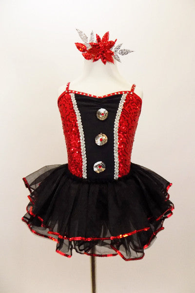 Red sparkle sequin bodice has black satin insert  with sequined-crystal buttons, silver cording & crystalled straps. Has attached sequined ruffle skirt. Front