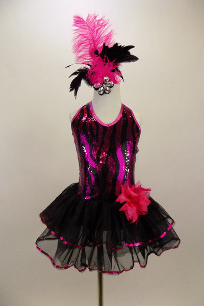Wavy pattern sequined vest with halter-neck has attached two layered black skirt with fuchsia sequined trim. Comes with hip flower accent & feathered hair accessory. Front