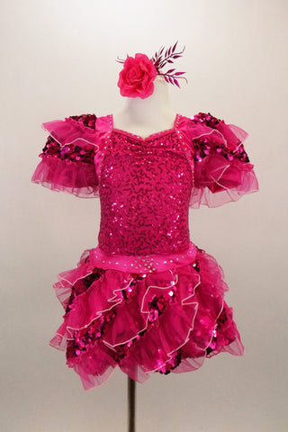 Fuchsia costume has organza ruffle sequin mesh on  sleeves & bubble skirt. The sequined bodice  is covered with crystals. Comes with matching hair accessory. Front