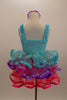 Pale aqua sequined dress has ruffled straps & pink-purple floral accent at left shoulder. Skirt has 3 tiers of pastel ruffles & matching hair accessory. Back