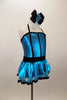 Turquoise metallic halter dress has black vertical piping & waistband with crystals. There is an attached black velvet edged petticoat skirt. Has matching hair accessory. Right side