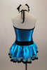 Turquoise metallic halter dress has black vertical piping & waistband with crystals. There is an attached black velvet edged petticoat skirt. Has matching hair accessory. Back