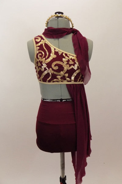 Maroon costume has golden brocade pattern, gold binding and an attached stretch-mesh scarf & asymmetrically draped skirt. Has high-waisted shorts & hair accessory. Front