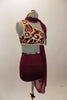Maroon costume has golden brocade pattern, gold binding and an attached stretch-mesh scarf & asymmetrically draped skirt. Has high-waisted shorts & hair accessory. Right side