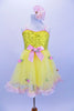 Yellow tutu dress has sequin bodice with satin bow & rose at front. Skirt is layers of yellow tricot with  pale pink satin rosettes. Has matching hair accessory. Front