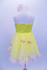 Yellow tutu dress has sequin bodice with satin bow & rose at front. Skirt is layers of yellow tricot with  pale pink satin rosettes. Has matching hair accessory. Back