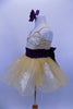 White lace appliqués adorn the champagne stretch-satin camisole bodice & attached gold sparkle tutu skirt. Has wide eggplant cummerbund with large back bow. Has matching hair accessory. Left side