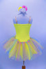 Sequin mesh overlays front bodice of  camisole leotard with silver braid trim. Rainbow sparkle tulle rests on yellow tricot tutu. Roses accent waist and hair. Back