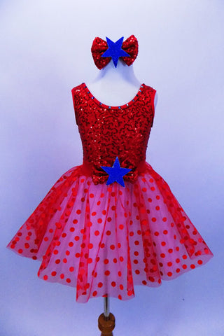 Red tank leotard dress has sequined bodice with large bow with blue star applique, Skirt is layers of white tricot with red polka dot mesh & matching hair piece. Front