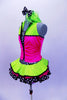 Sequined zebra-print  biketard has separate pink & lime zippered vest. The attached cerise pink & lime layered ruffle skirt has polka dot ribbon accent. Comes with matching hair accessory. Left side