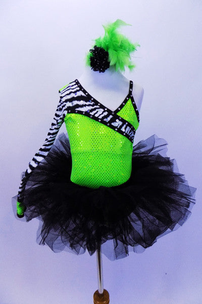 Neon green asymmetrical sequined one shoulder leotard with zebra print sleeve and bodice accent. Comes with black tutu skirt and matching feather hair accessory. Front