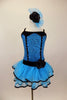 Blue sequin leotard has black velvet accents with crystals. Black satin rosettes accent the waist & hair accessory. Has ruffle layer skirt with black trim. Front