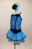 Blue sequin leotard has black velvet accents with crystals. Black satin rosettes accent the waist & hair accessory. Has ruffle layer skirt with black trim. Left side