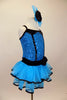 Blue sequin leotard has black velvet accents with crystals. Black satin rosettes accent the waist & hair accessory. Has ruffle layer skirt with black trim. Right side