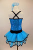 Blue sequin leotard has black velvet accents with crystals. Black satin rosettes accent the waist & hair accessory. Has ruffle layer skirt with black trim. Back