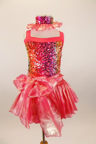 Iridescent coral organza full skirt & ties wrap the waist in a front bow. Rainbow sequin sparkles cover the bodice. Has sequin mesh choker with organza ruffle. Front