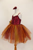 Rich earth-tone tutu dress has burgundy sequined bodice. Skirt is glitter ombré tulle over burgundy tulle layers with gold floral accent & hair accessory.  Left side