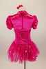 Hot pink stretch satin ruched dress has attached bolero with crystal accents,a  tulle skirt with silver polka dots & pouf sleeves. Comes with hair accessory. Back
