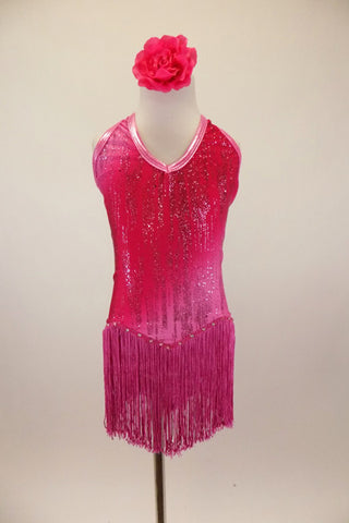 Pink halter neck,flapper style leotard dresses has open back with crystalled straps fringe skirt & waves of dark and light pink with vertical glitter pattern. Comes with floral hair accessory. Front