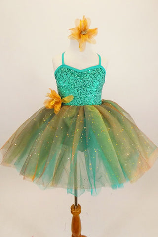 Aqua  jewel-tone tutu dress has sequin spandex front with cross straps. Skirt is glitter ombré tulle & soft aqua  beneath. Has gold flower at waist & for hair. Front
