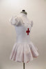 White pouf sleeved nurse’s dress had red petticoat & attached pinafore with large red cross on the front. Comes with matching nurse hat. Side