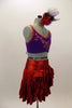 Shiny red ruffled layer skirt has matching purple bra top has red piping accent, red lace-up corset back & front with hand painted swirls and crystals. Comes with matching hair accessory. Side