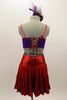 Shiny red ruffled layer skirt has matching purple bra top has red piping accent, red lace-up corset back & front with hand painted swirls and crystals. Comes with matching hair accessory. Back