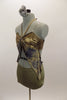Gold bra top has “V” halter neck strap & attached grey-blue and taupe marbleized kerchief accent attached to bra. Has matching taupe shorts & hair accessory. Left side