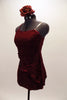 Deep red velvet two-piece costume with red sparkle & metallic accents accents, comes with asymmetrical kerchief top to match shorts. Has flower hair accessory. Left side