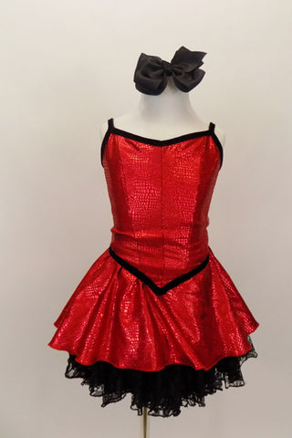Red textured metallic dress has princess cut bodice and attached skirt with black lace petticoat. Has black piping and snapback closure. Comes with black bow hair accessory. Front