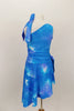 Asymmetrical tank style dress has tie-dye pattern in shade of blues. Sides of the dress are gathered with ties for better fit. Comes with matching hair tie. Back