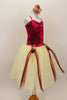 Wine colored crush velvet bodice, has attached cream tulle skirt with wine colored ribbon attached to rose clusters cascading at sides. Has floral hair accessory. Side