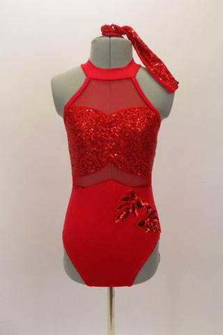 Red leotard has halter style front with open back, neck closure & vertical straps. Bodice is sheer with sequined sweetheart bust & bottom is solid red with applique accents. Front