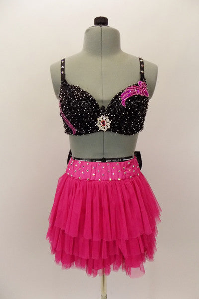 Costume is a  pink layered mesh skirt with crystal covered waistband & large black crystal covered bow at back. Beaded black bra has crystal brooch & appliques. Comes with fancy headband. Front