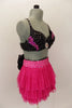 Costume is a  pink layered mesh skirt with crystal covered waistband & large black crystal covered bow at back. Beaded black bra has crystal brooch & appliques. Comes with fancy headband. Right side