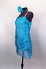 Single shoulder tunic dress has built in leotard & embroidered turquoise daisy flower lace with crystal accents in flower centers. Comes with hair accessory. Left side